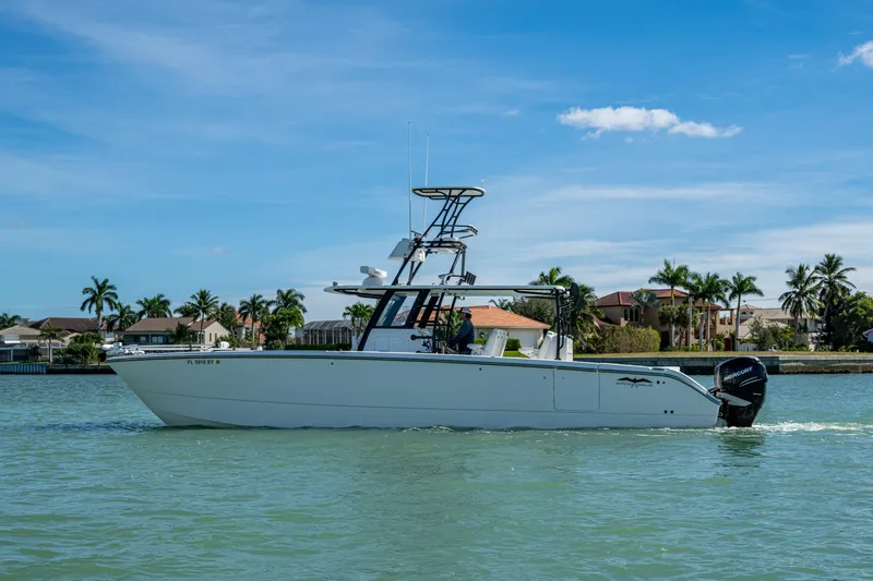 Slide: The Image of 2021 Invincible 40 Catamaran cruising on a sunny day near waterfront homes. - 6