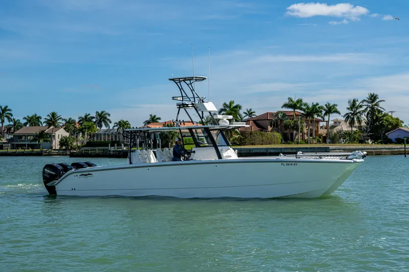 Slide: The Image of 2021 Invincible 40 Catamaran cruising on a sunny day near waterfront homes. - 66