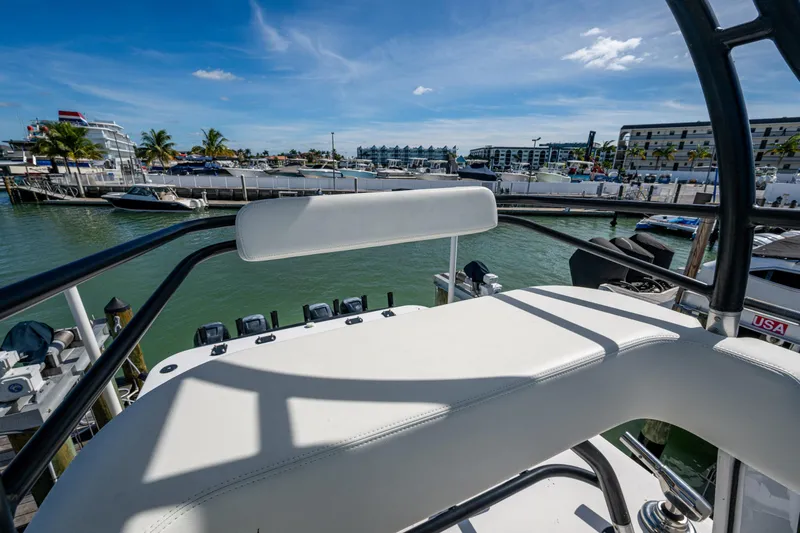 Slide: The Image of 2021 Invincible 40 Catamaran helm view at marina, clear skies, and waterfront buildings. - 70