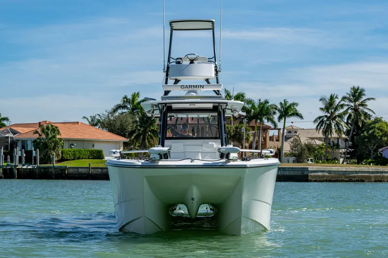 Slide: The Image of 2021 Invincible 40 Catamaran on water, with tropical backdrop and clear sky. - 8