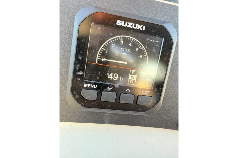 Slide: The Image of Suzuki boat tachometer displaying 49 hours on a Carolina Skiff 1980 V, 2001 model. - 5