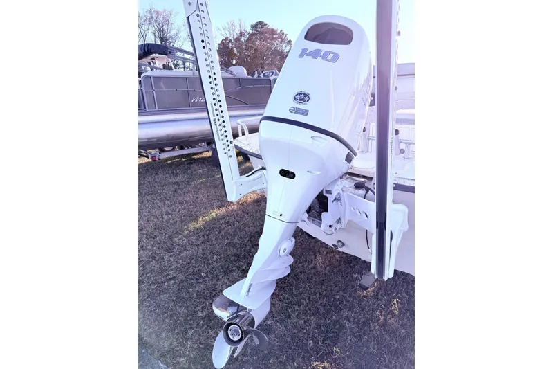 Slide: The Image of Outboard motor on a 2001 Carolina Skiff 1980 V boat, displayed outdoors. - 7