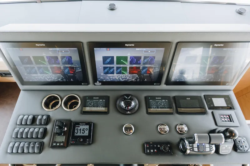 Slide: The Image of Control panel of 2024 Beneteau Grand Trawler 62 with advanced navigation displays and controls. - 12