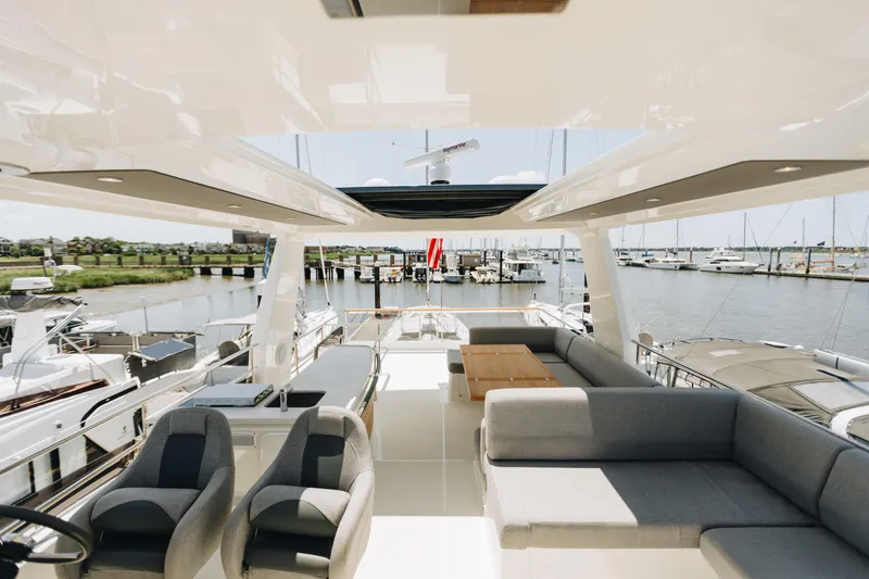 Slide: The Image of Luxurious 2024 Beneteau Grand Trawler 62 yacht interior with spacious seating and marina view. - 13