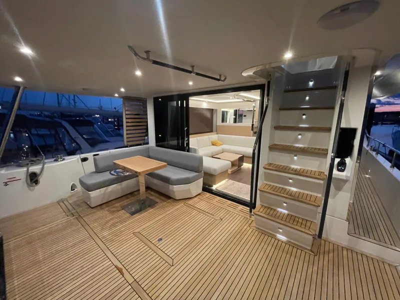 Slide: The Image of Luxurious interior of 2024 Beneteau Grand Trawler 62 with elegant seating and wooden flooring. - 22