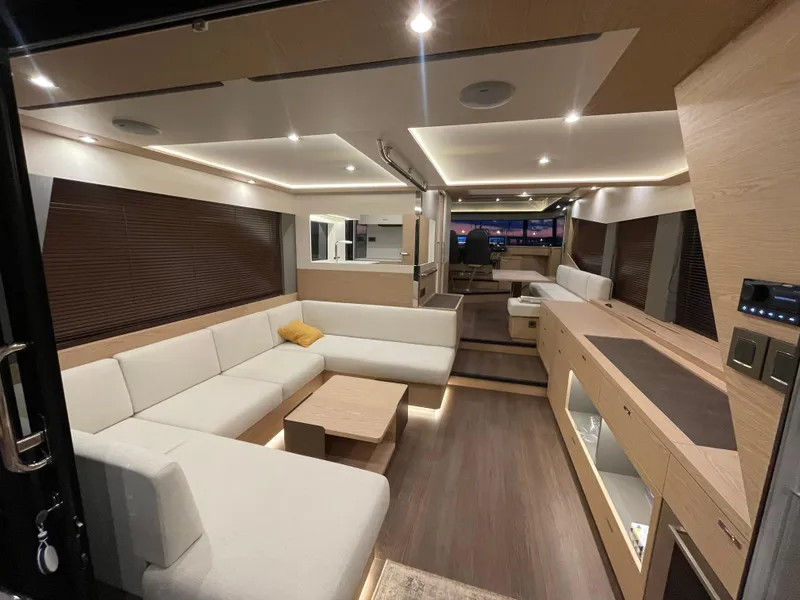 Slide: The Image of Luxurious interior of 2024 Beneteau Grand Trawler 62 with modern furnishings and ambient lighting. - 23