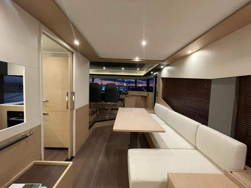 Slide: The Image of Luxurious interior of 2024 Beneteau Grand Trawler 62 with modern seating and dining area. - 24