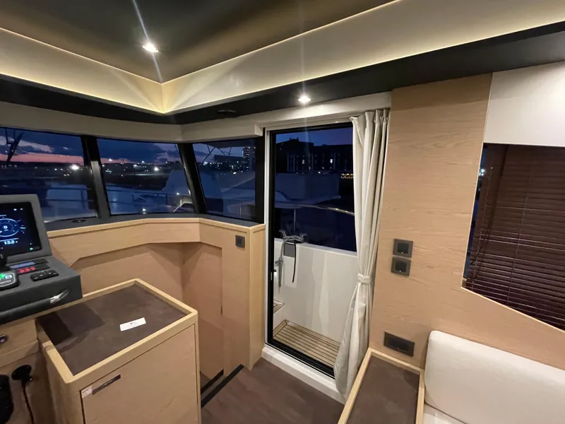 Slide: The Image of Interior of 2024 Beneteau Grand Trawler 62, featuring modern design and panoramic windows. - 26