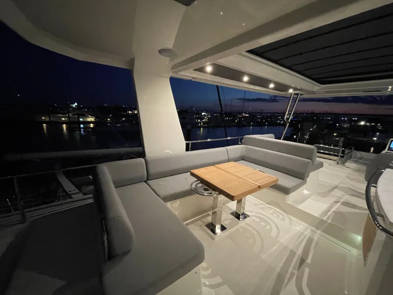 Slide: The Image of Luxurious 2024 Beneteau Grand Trawler 62 yacht deck at sunset, featuring elegant seating. - 30