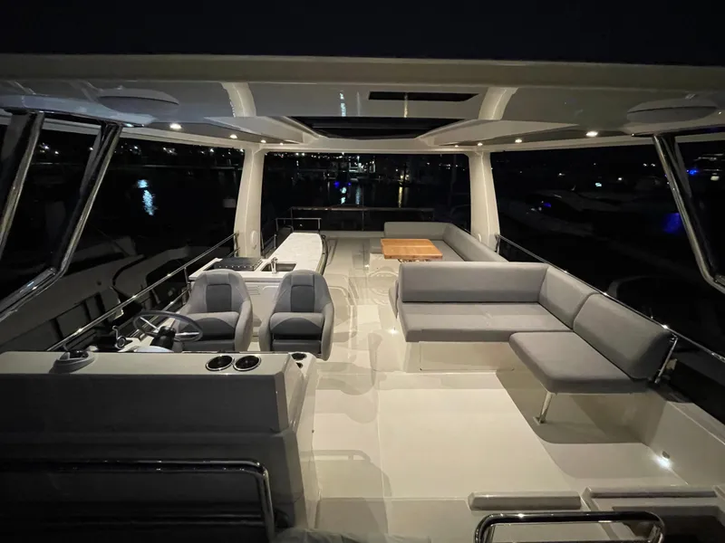 Slide: The Image of Luxurious 2024 Beneteau Grand Trawler 62 yacht interior with seating and helm at night. - 33