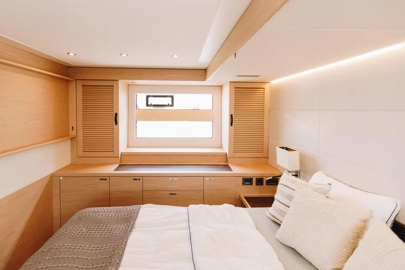Slide: The Image of Luxurious cabin interior of 2024 Beneteau Grand Trawler 62 with modern wood finishes. - 37