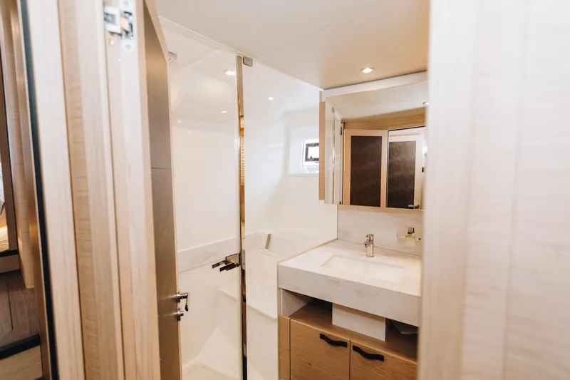 Slide: The Image of Luxurious bathroom in 2024 Beneteau Grand Trawler 62 yacht, featuring modern fixtures and elegant design. - 41