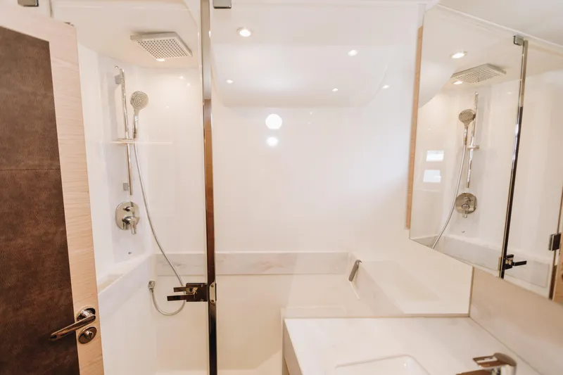 Slide: The Image of Luxurious bathroom in 2024 Beneteau Grand Trawler 62 yacht, featuring modern shower and sleek design. - 42