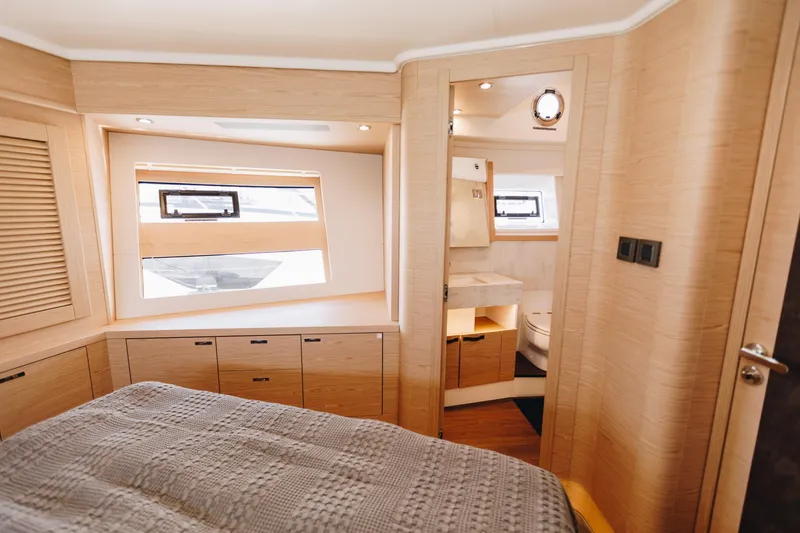Slide: The Image of Luxurious interior of 2024 Beneteau Grand Trawler 62, featuring a cozy bedroom and modern bathroom. - 44