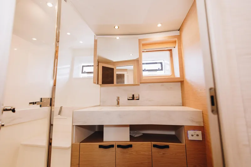 Slide: The Image of Luxurious bathroom interior of 2024 Beneteau Grand Trawler 62 yacht, featuring modern fixtures and wood accents. - 46