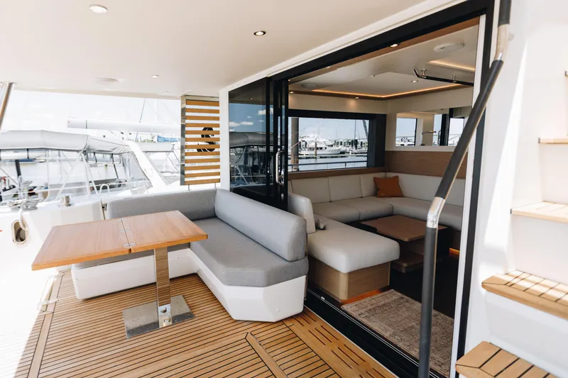 Slide: The Image of 2024 Beneteau Grand Trawler 62 interior with modern seating and wooden accents. - 6