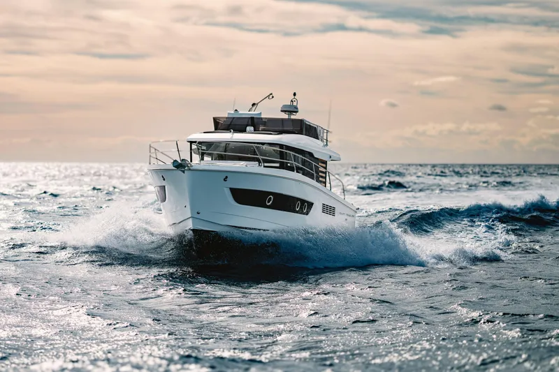 Slide: The Image of 2026 Beneteau Swift Trawler 37 Fly cruising on open sea at sunset. - 1
