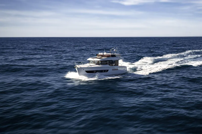 Slide: The Image of 2026 Beneteau Swift Trawler 37 Fly cruising on open sea under clear skies. - 18