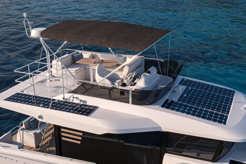 Slide: The Image of 2026 Beneteau Swift Trawler 37 Fly with solar panels, cruising on clear blue water. - 4