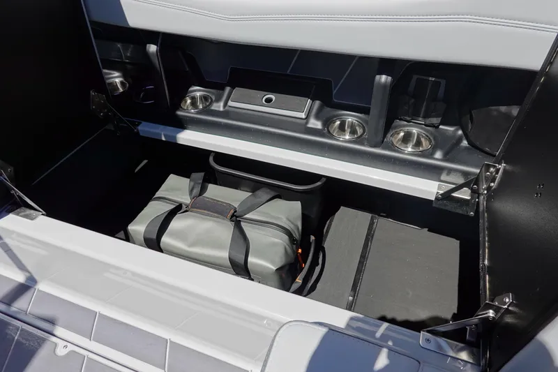 Slide: The Image of Storage compartment in 2026 Malibu Wakesetter 22 LSV boat with bag and cup holders. - 16