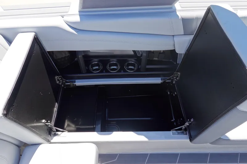 Slide: The Image of 2026 Malibu Wakesetter 22 LSV interior storage compartment with open lids. - 20