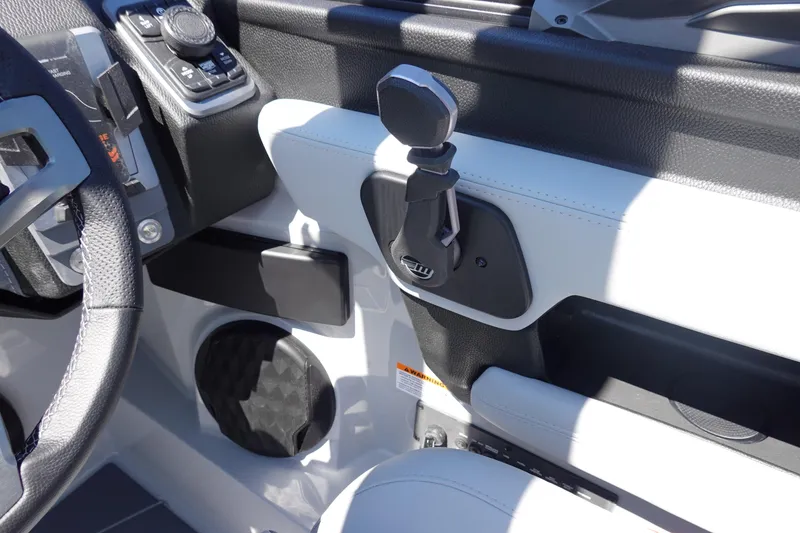 Slide: The Image of Interior controls of 2026 Malibu Wakesetter 22 LSV boat, featuring steering and audio system. - 26