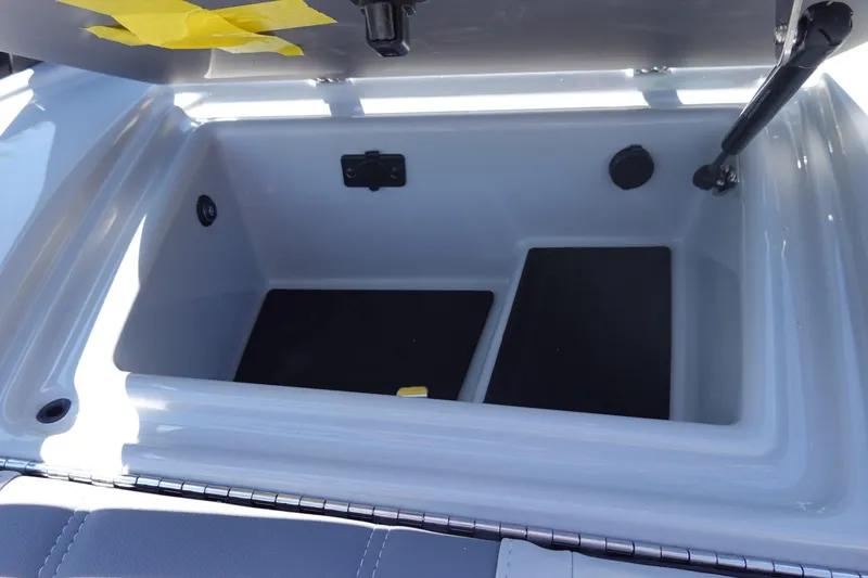 Slide: The Image of 2026 Malibu Wakesetter 22 LSV storage compartment with open lid and hydraulic support. - 31