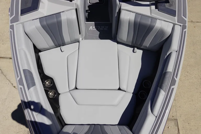 Slide: The Image of 2026 Malibu Wakesetter 22 LSV boat interior with gray seating and cup holders. - 33