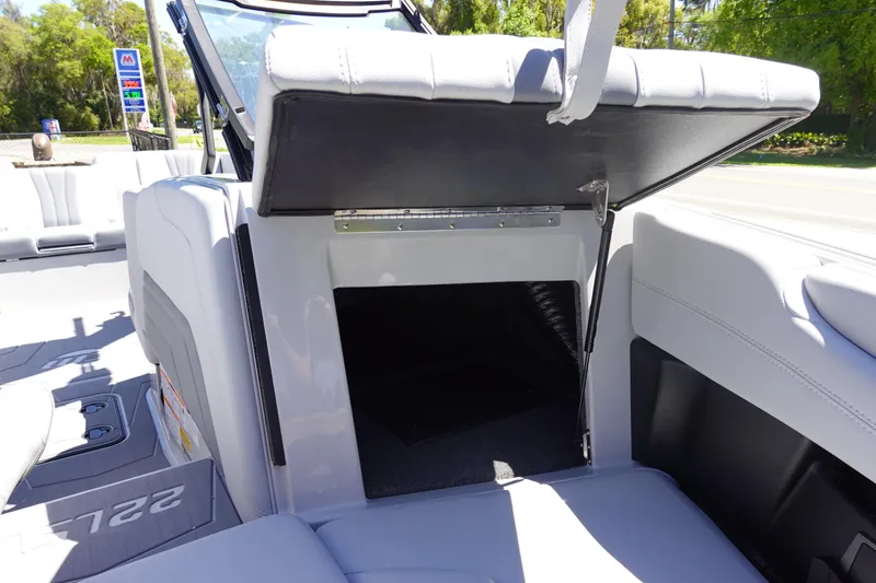 Slide: The Image of 2026 Malibu Wakesetter 22 LSV storage compartment with open seat. - 36
