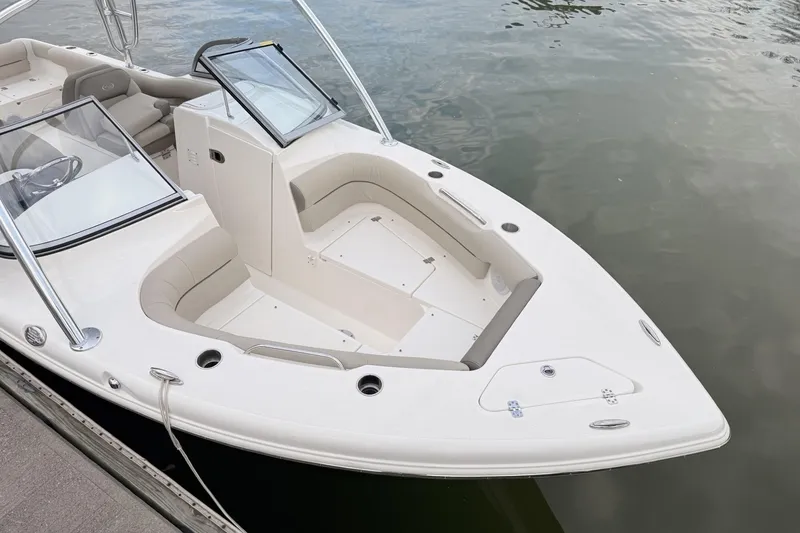 Slide: The Image of 2024 Key West 239 DFS boat docked, showcasing spacious seating and sleek design. - 2