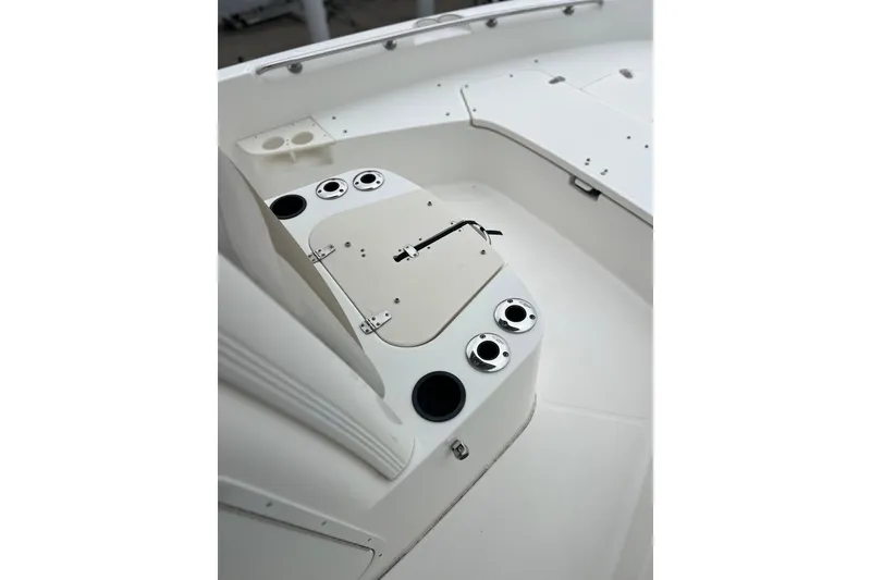 Slide: The Image of 2018 Boston Whaler 210 Dauntless boat interior with rod holders and storage compartments. - 13