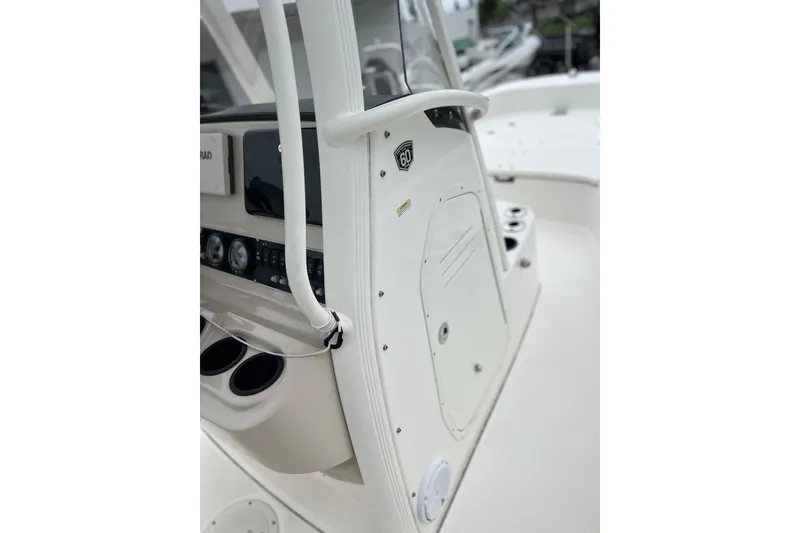 Slide: The Image of 2018 Boston Whaler 210 Dauntless boat console with gauges and storage compartment. - 14