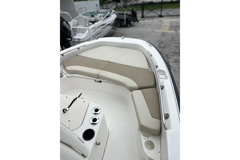 Slide: The Image of 2018 Boston Whaler 210 Dauntless boat interior with cushioned seating and control panel. - 17