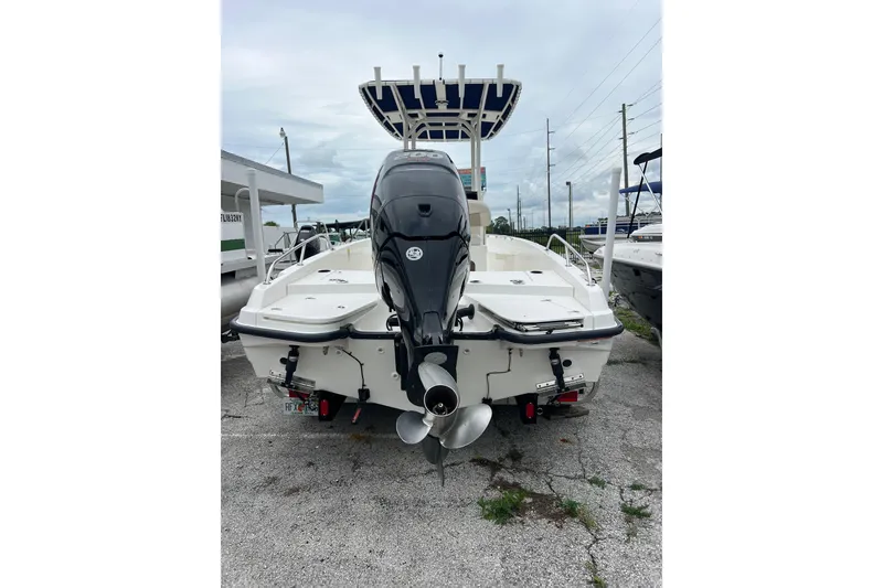 Slide: The Image of 2018 Boston Whaler 210 Dauntless boat with outboard motor, parked on concrete. - 6