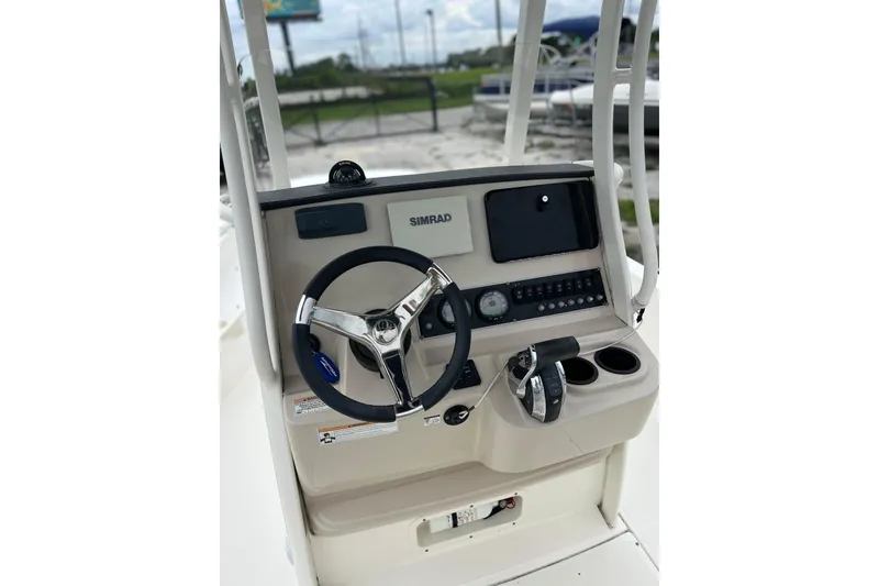 Slide: The Image of 2018 Boston Whaler 210 Dauntless boat console with steering wheel and controls. - 8