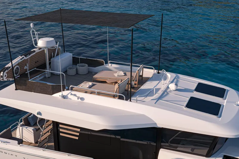 Slide: The Image of 2026 Beneteau Swift Trawler 37 Sedan with spacious deck and sunshade on calm water. - 5