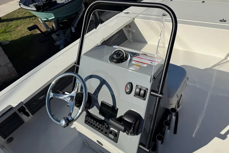 Slide: The Image of 2026 Hewes Redfisher 21 boat console with steering wheel and controls. - 10