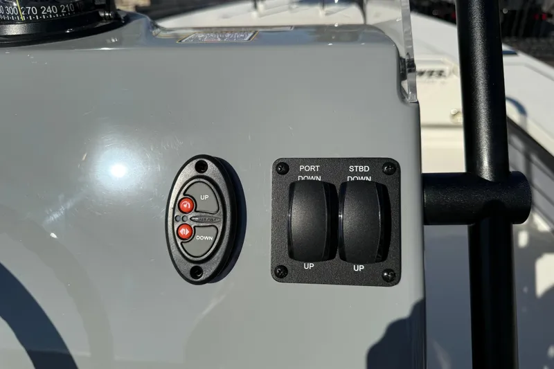 Slide: The Image of Control panel of 2026 Hewes Redfisher 21 boat with switches and buttons. - 14