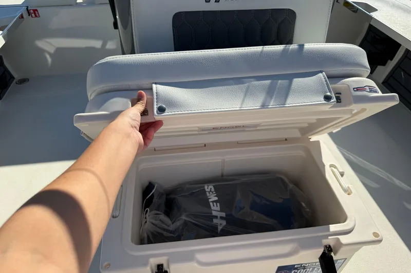 Slide: The Image of 2026 Hewes Redfisher 21 boat seat storage compartment with Engel cooler. - 20