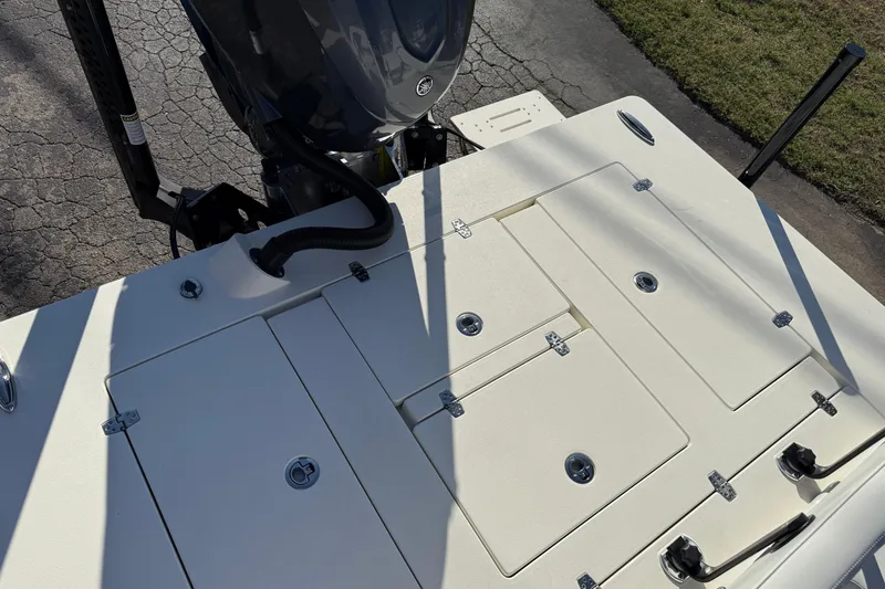 Slide: The Image of 2026 Hewes Redfisher 21 boat deck with storage compartments and motor. - 23