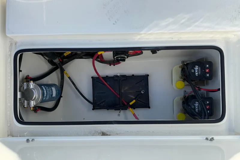 Slide: The Image of 2026 Hewes Redfisher 21 boat compartment with wiring and battery setup. - 25
