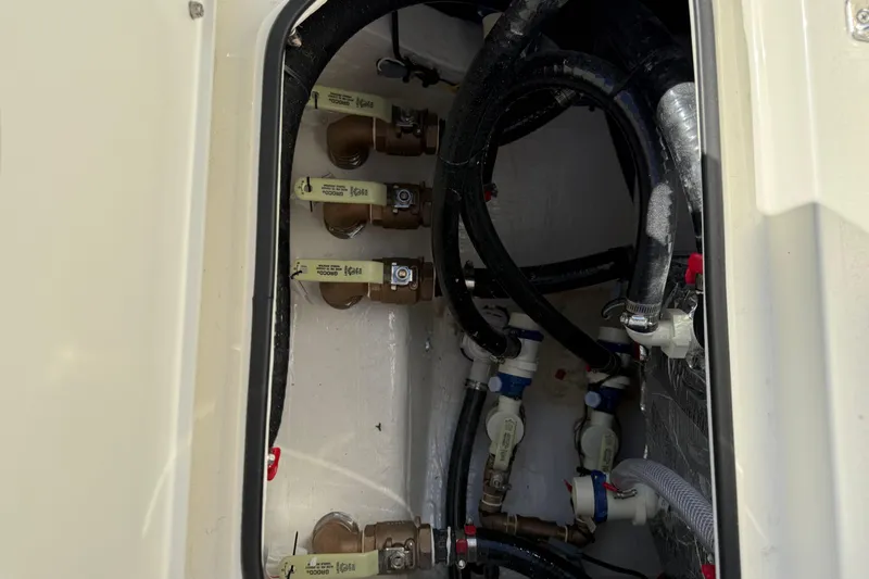 Slide: The Image of 2026 Hewes Redfisher 21 boat plumbing system with valves and hoses. - 26