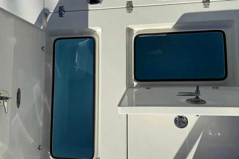 Slide: The Image of 2026 Hewes Redfisher 21 boat interior with storage compartments and latch. - 28