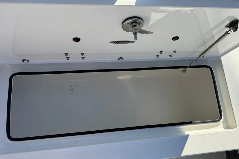 Slide: The Image of 2026 Hewes Redfisher 21 boat storage compartment with open lid and hydraulic support. - 31