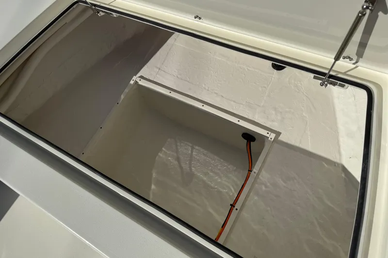 Slide: The Image of Open storage compartment in 2026 Hewes Redfisher 21 boat, featuring a clean interior design. - 38