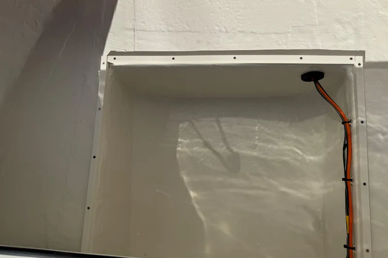 Slide: The Image of Interior compartment of 2026 Hewes Redfisher 21 boat with visible wiring. - 39