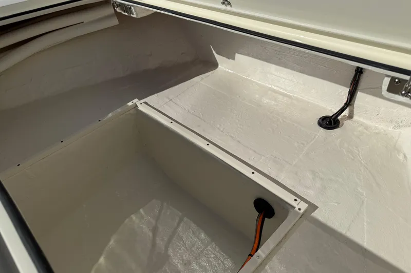 Slide: The Image of 2026 Hewes Redfisher 21 boat storage compartment with wiring details. - 40