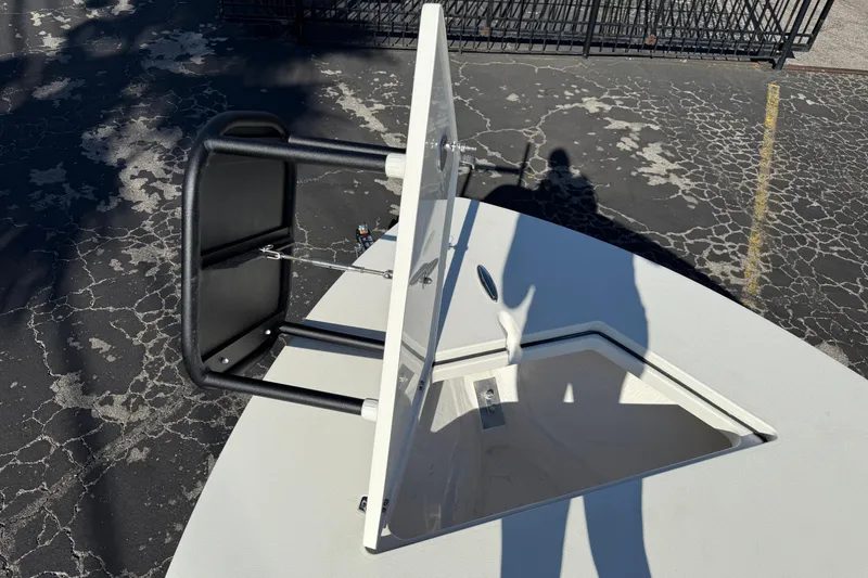 Slide: The Image of 2026 Hewes Redfisher 21 boat hatch open, showing interior storage compartment. - 42