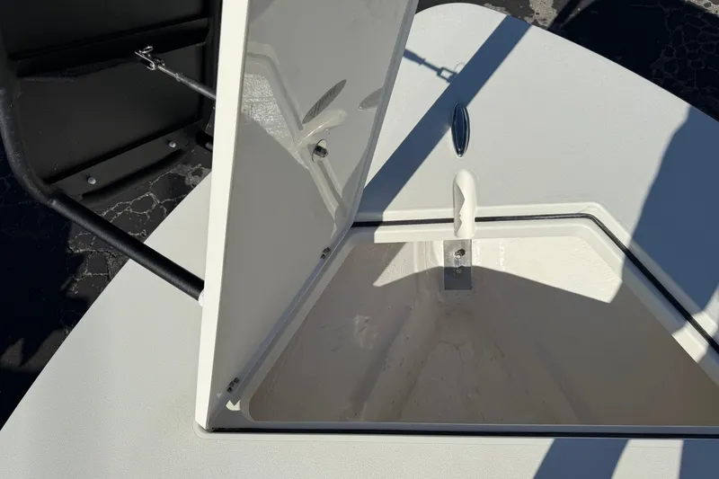 Slide: The Image of Open storage compartment on 2026 Hewes Redfisher 21 boat, showcasing interior details. - 43