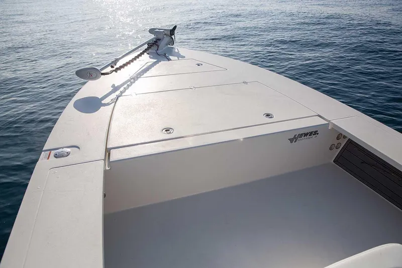 Slide: The Image of Manufacturer Provided Image: 2026 Hewes Redfisher 21 boat on calm water, showcasing sleek deck design. - 46